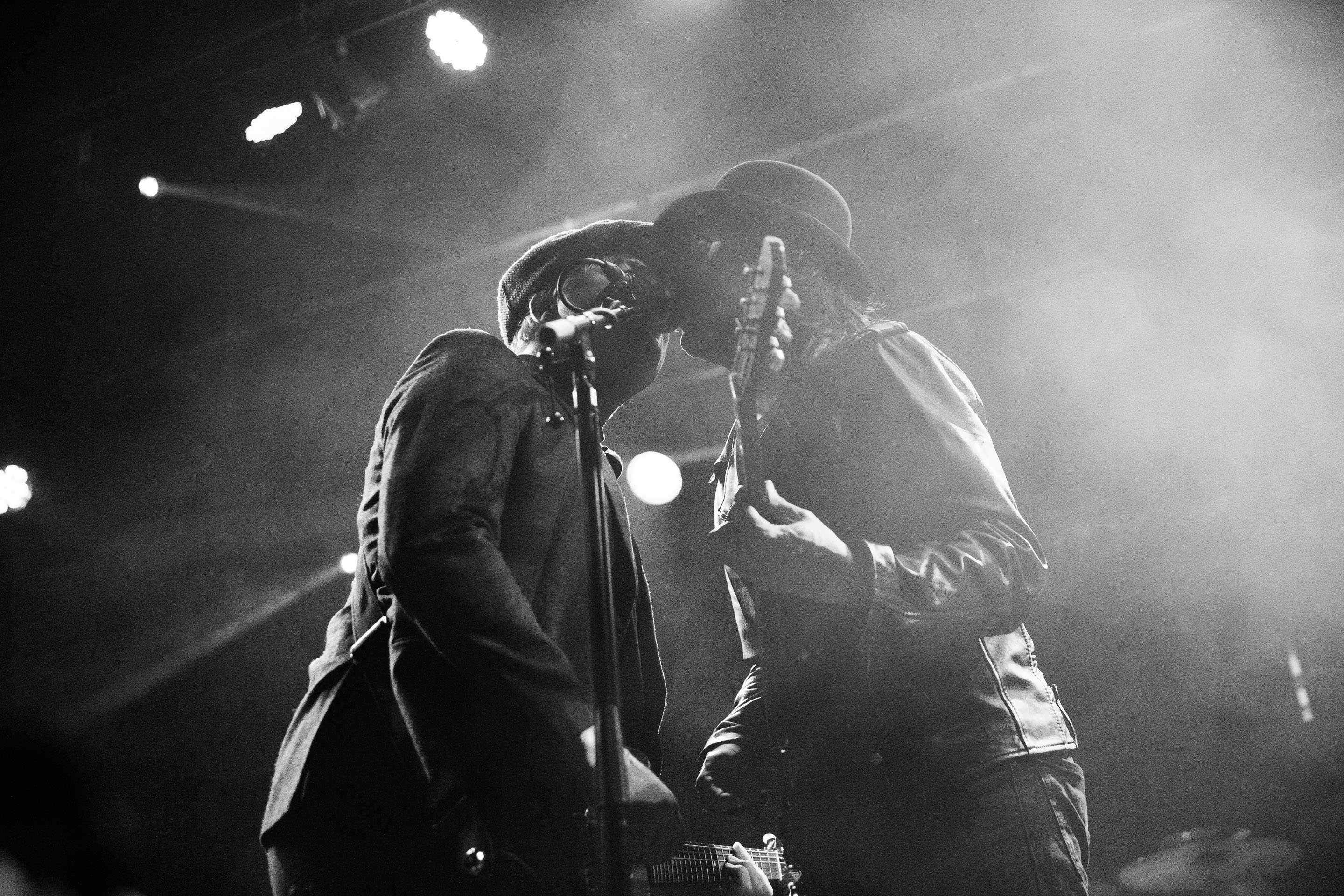 Pete Doherty and Carl Barât of The Libertines singing into the microphone while both playing their guitars at Princess Pavilion Falmouth.